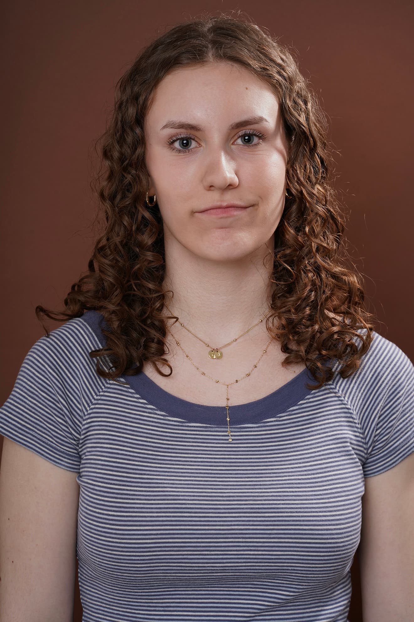 Maya Cassell headshot on a warm studio backdrop